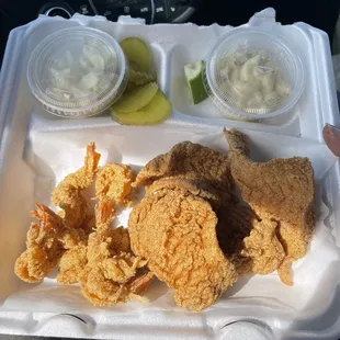 a tray of fried chicken and pickles
