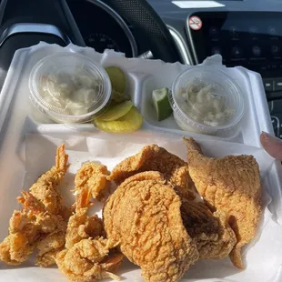 a tray of fried chicken and pickles