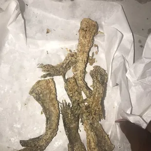 a piece of fried fish in a paper bag