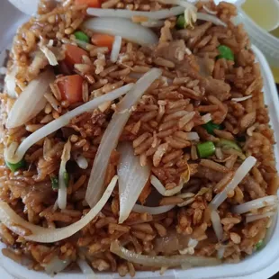 a plate of rice and vegetables in a styrofoam container