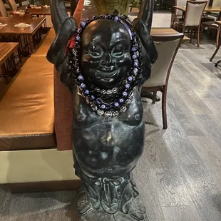 Happy Buddha greets you entering dining area
