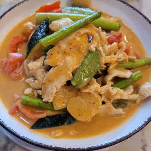 Panang chicken with onion,  bamboo, asparagus,  baby corn, zucchini, tomato,  peapood in red curry sauce