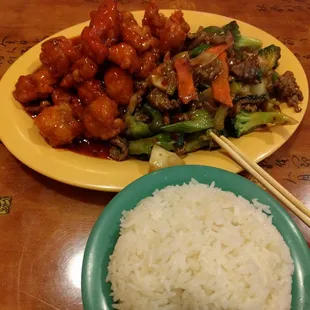 a plate of chinese food and a bowl of rice