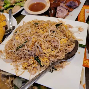 a plate of noodles with meat and vegetables