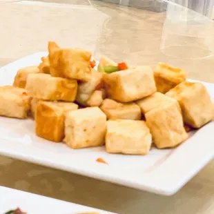 a plate of tofu and vegetables