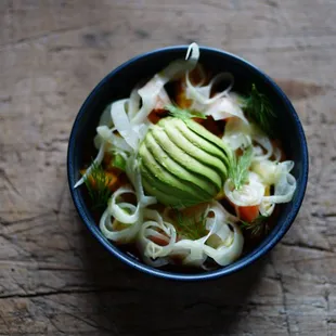 a bowl of noodles and avocado