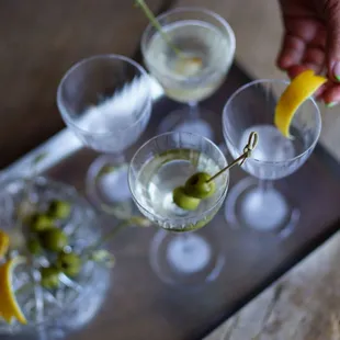 olives being squeezed into glasses