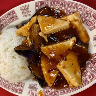 a plate of food with rice and tofu