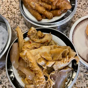 Dim sum dishes- (top) chicken feet (bottom) mixed tapa plate of beef tripe