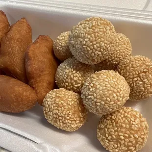 a tray of sesame balls and doughnuts