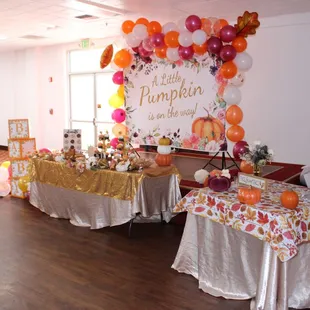 a decorated hall with tables and balloons