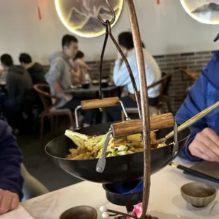 a man sitting at a table with a plate of food