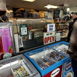 a man standing in front of an ice cream shop