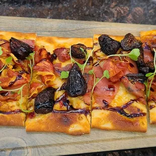 a flatbread pizza on a cutting board