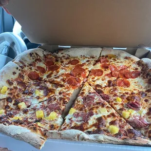 Half pepperoni &amp; half kalua pork and pineapple.. couldn&apos;t even close the box because the pizza is huge!