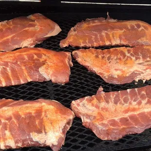 the meat being cooked on the grill