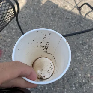 a person holding a cup of coffee