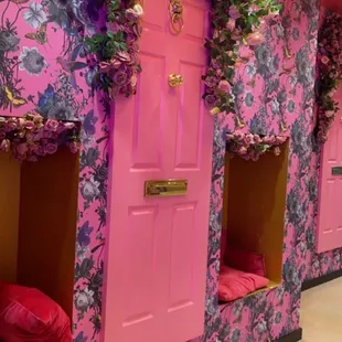 a pink room with pink doors and pink flowers