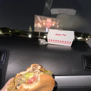 ows a hand holding a hot dog