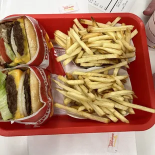 ows a tray of fries and a hamburger