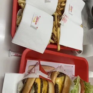 ows two trays of hamburgers and french fries