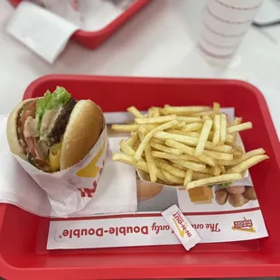 ows a tray of fries and a sandwich