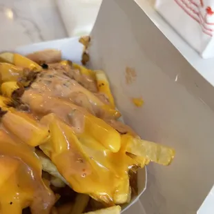 ows cheese fries in a paper container