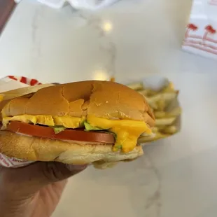 ows a hand holding a hot dog