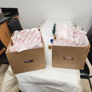 ows two boxes of food on a table