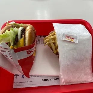 ows a red tray with a sandwich and fries