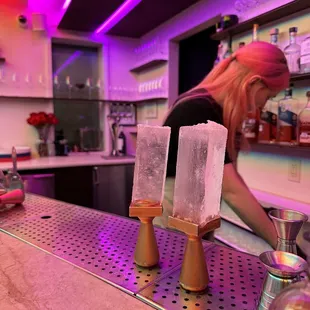 a woman preparing a drink at a bar