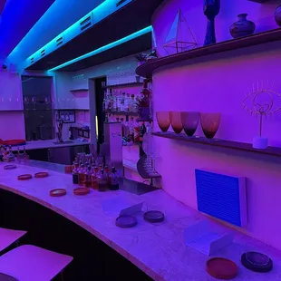 a bar with purple lighting