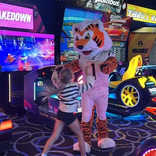 a tiger mascot and two children