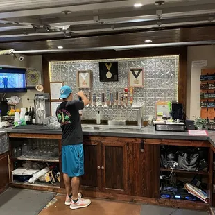 Taps and the man servin them up.