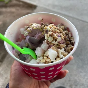 a hand holding a bowl of yogurt