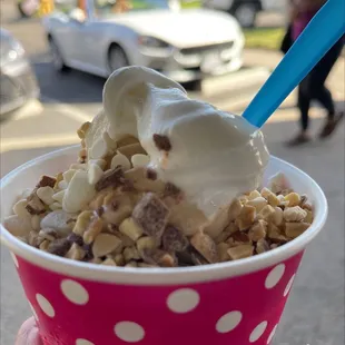 a hand holding a cup of ice cream