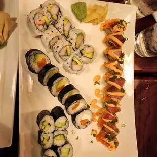 a plate of sushi and rolls