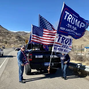 two people holding flags