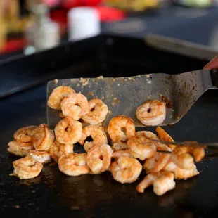 a person cutting up shrimp