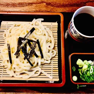 a plate of noodles and a cup of coffee