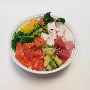 a bowl of sushi and vegetables