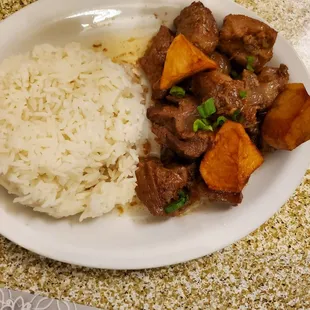 a plate of food with rice and meat