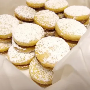 powdered sugar cookies in a paper bag
