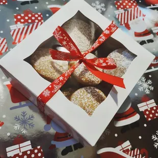 a box of cookies with a red ribbon