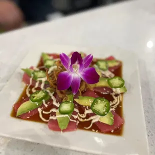 a plate of food with a flower on top