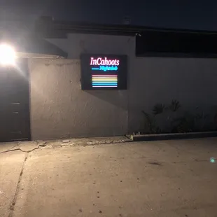 a neon sign in front of a building