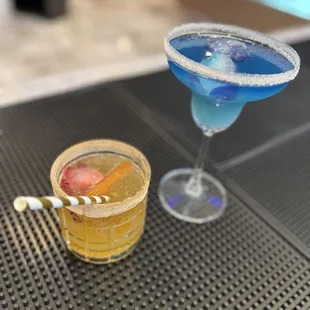 two cocktails on a bar