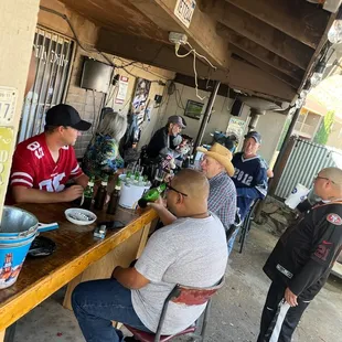 a group of men sitting at a bar