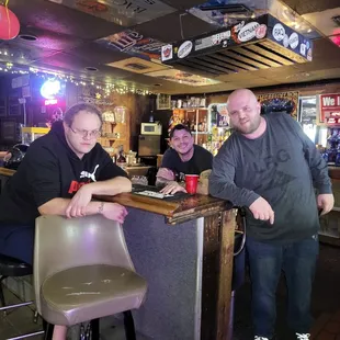 two men sitting at a bar