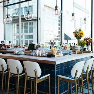 a bar with chairs and a counter